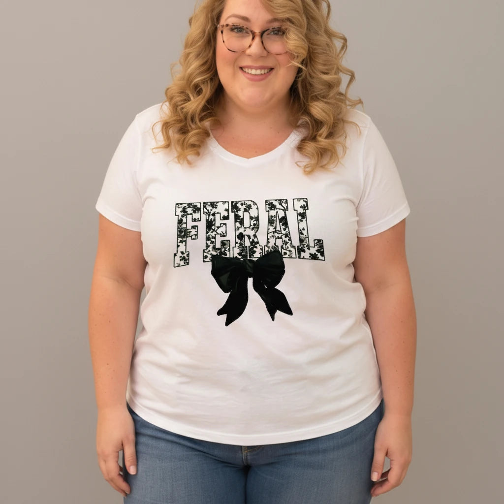 The Quirky Closet white cotton V-neck t-shirt with "FERAL" floral graphic and oversized dark green velvet bow.